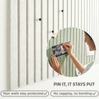 Close-up of felt bulletin board tiles with push pins holding postcards — pin stays put, wall protected
