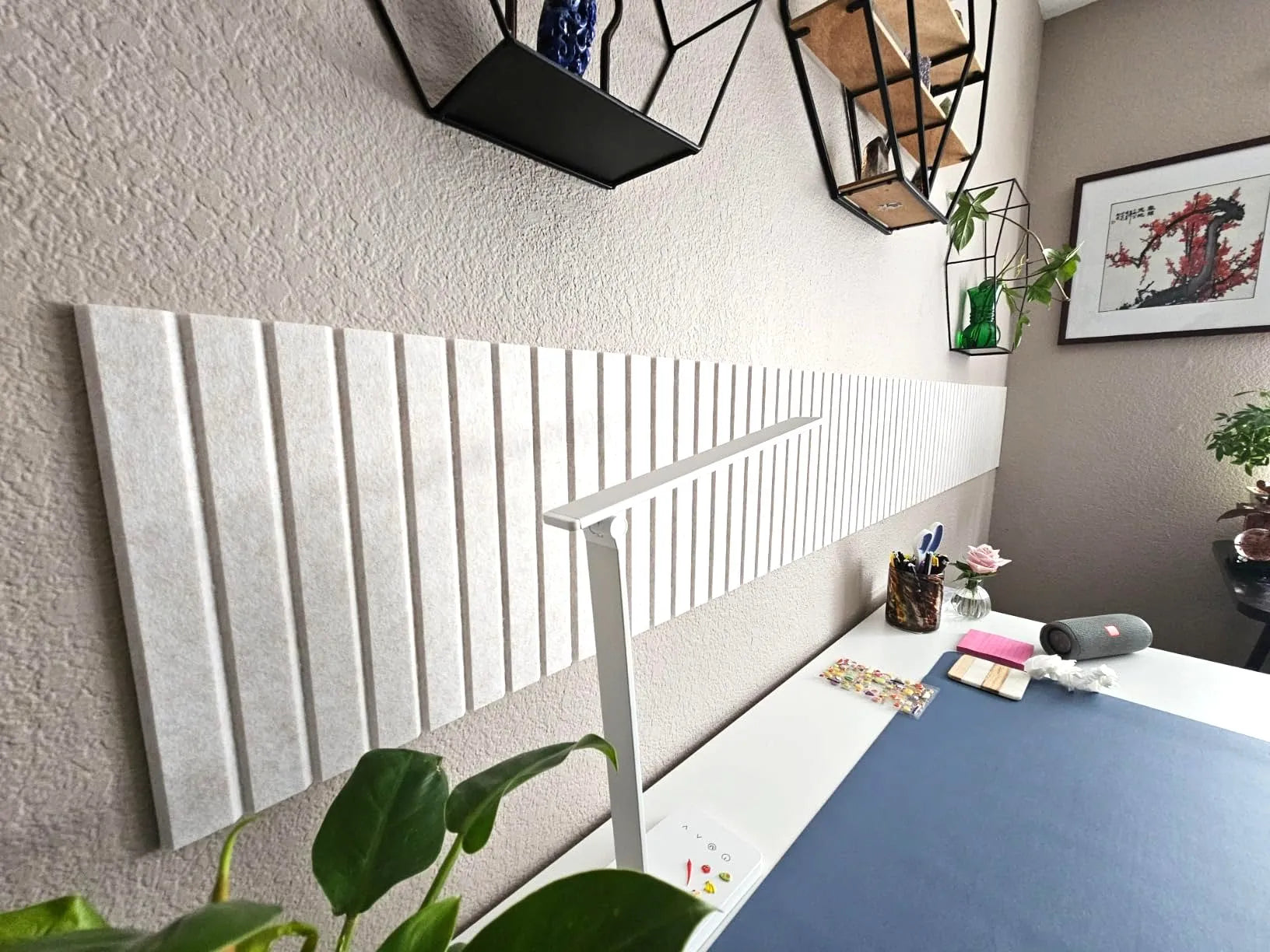 Vivelda limestone felt bulletin board tiles installed above a home office desk with plants and shelves lifestyle decor